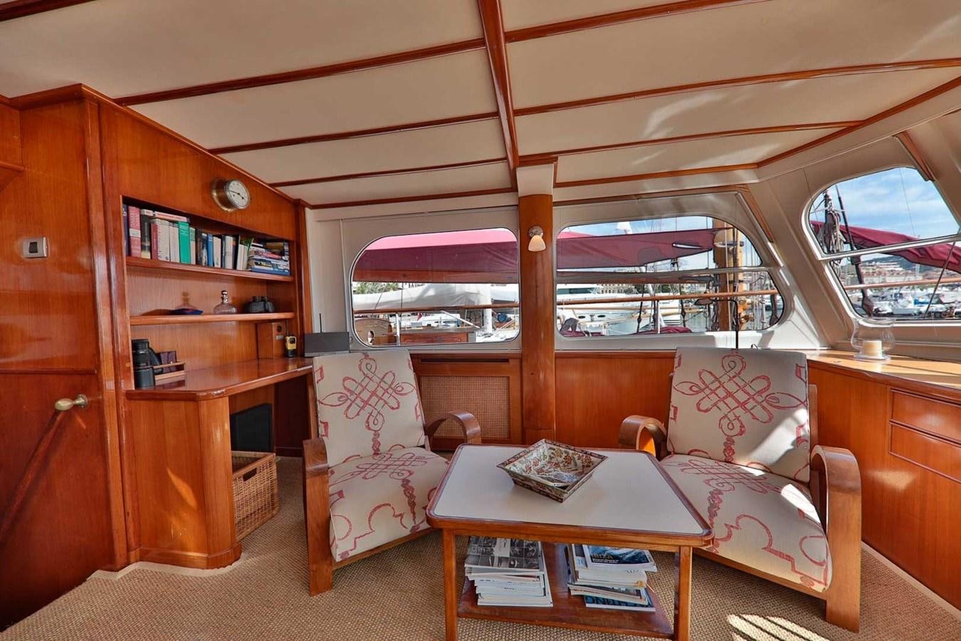 a living room with a large window aboard ATALANTA J Yacht for Sale