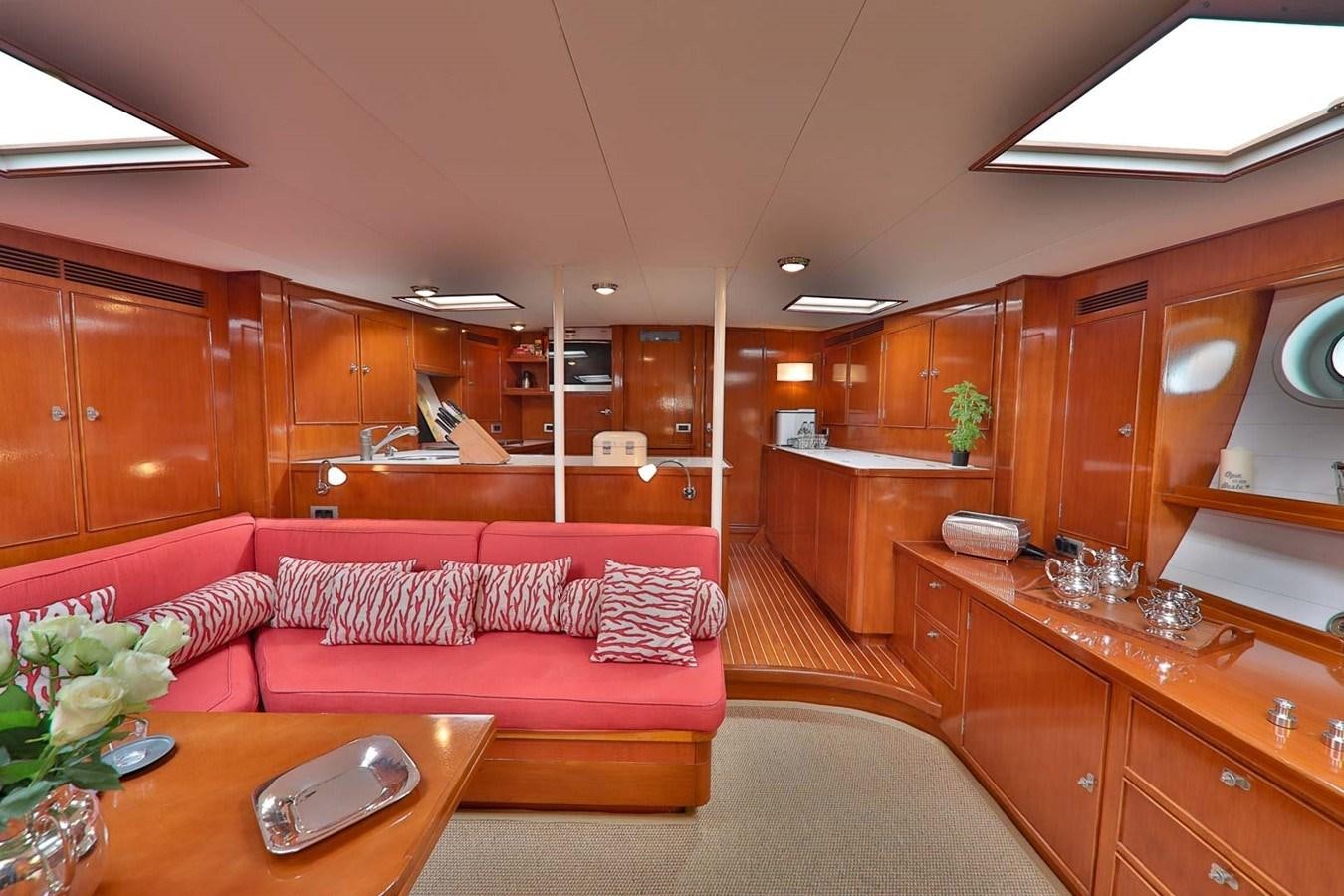 a living room with a red couch aboard ATALANTA J Yacht for Sale