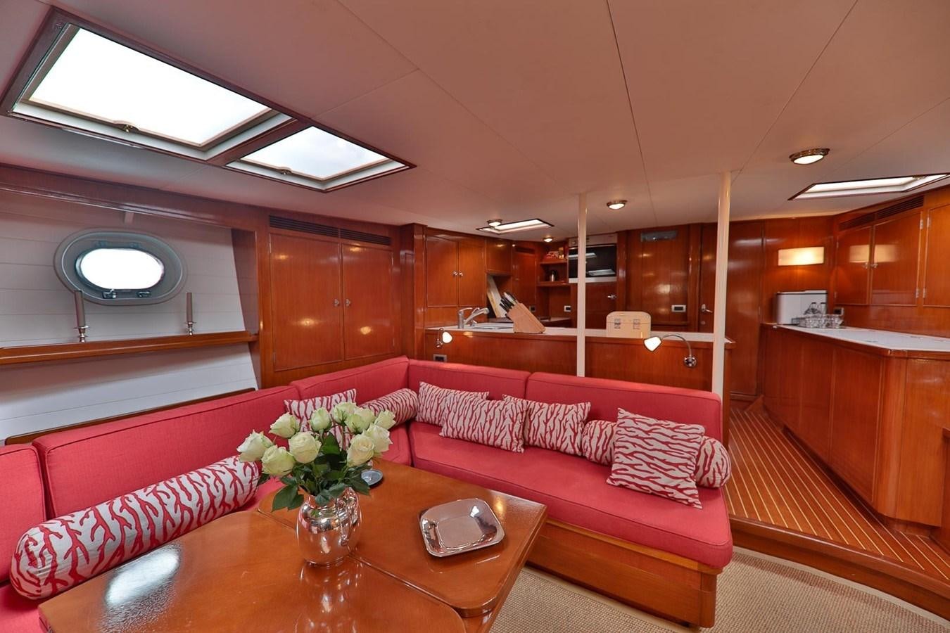 a living room with a red couch aboard ATALANTA J Yacht for Sale