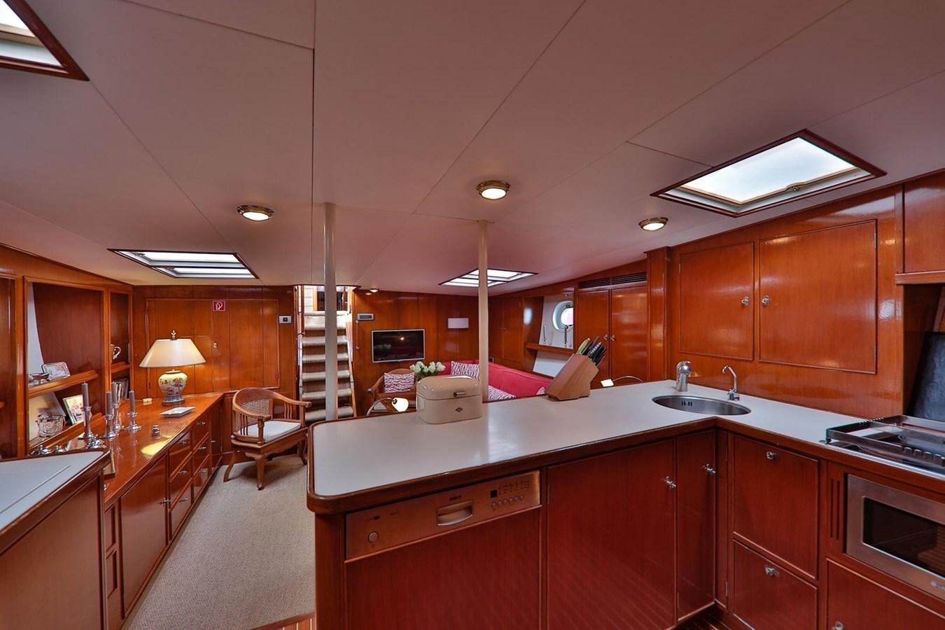 a kitchen with wooden cabinets aboard ATALANTA J Yacht for Sale