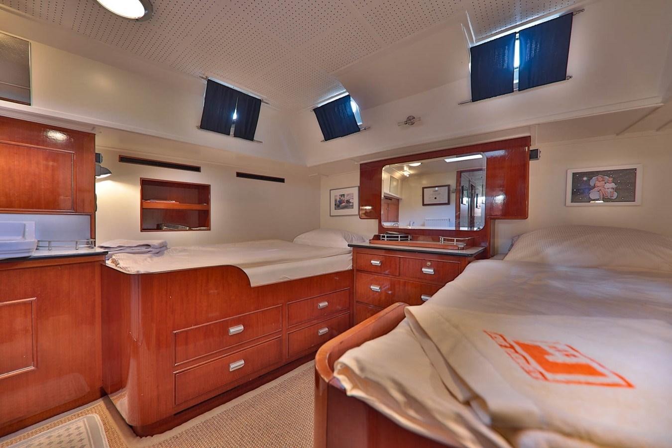 a room with a bed and a tv on the wall aboard ATALANTA J Yacht for Sale