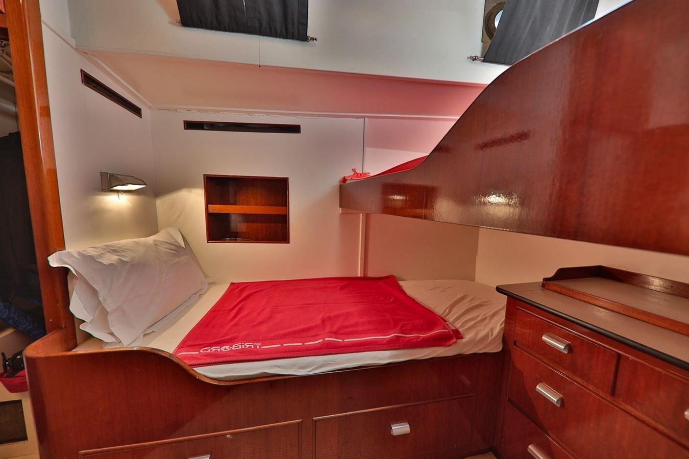 a room with a bed and a dresser aboard ATALANTA J Yacht for Sale