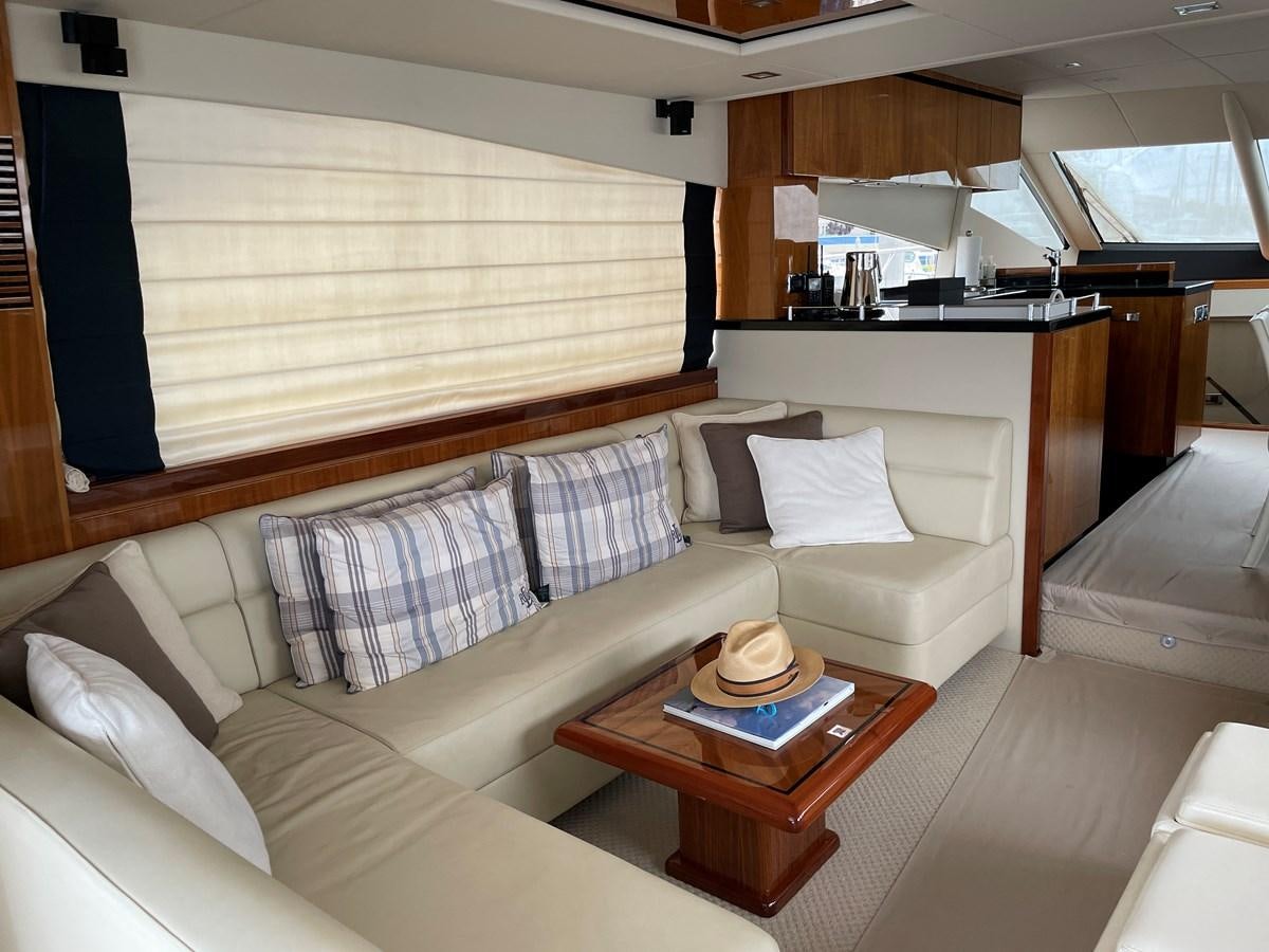a living room with a couch and a coffee table aboard GRACE ELLEN Yacht for Sale