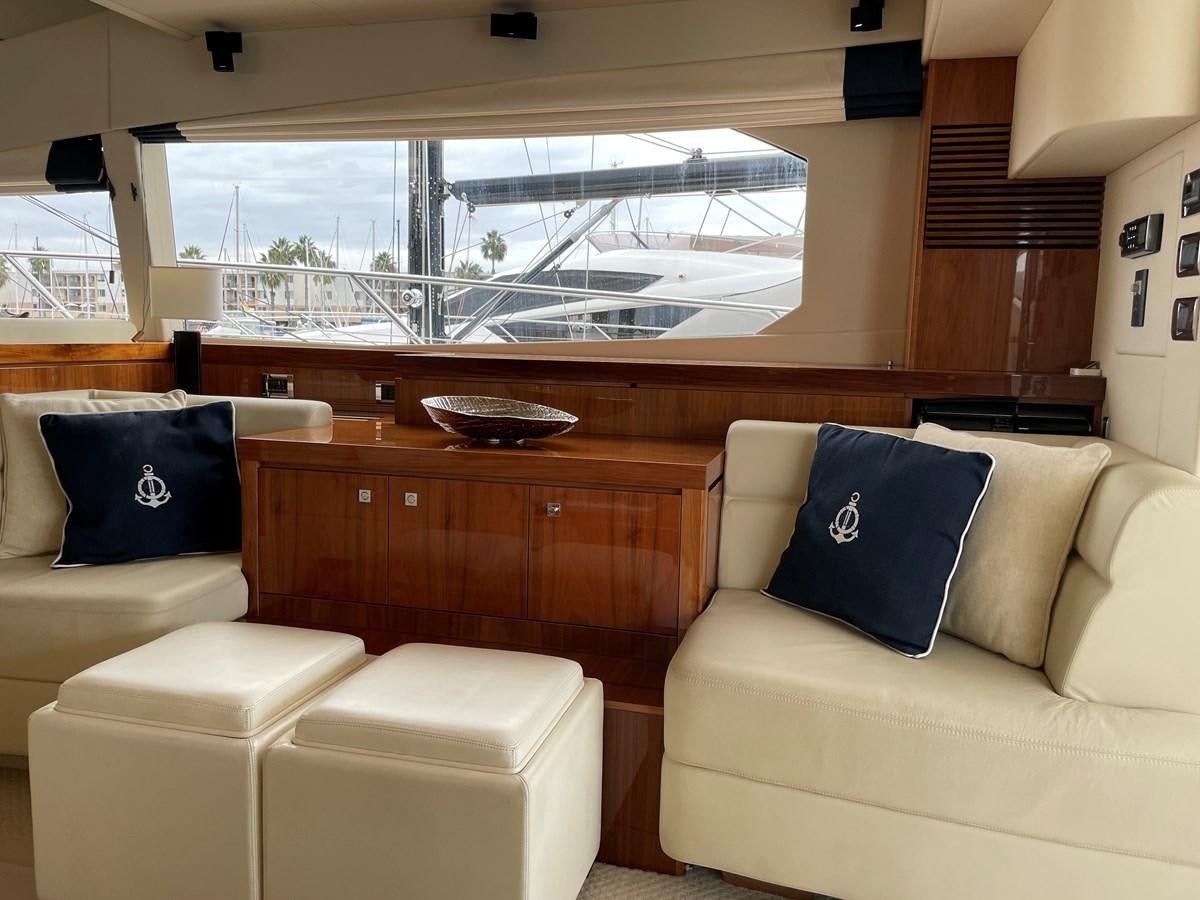 a room with a couch and a table with chairs aboard GRACE ELLEN Yacht for Sale