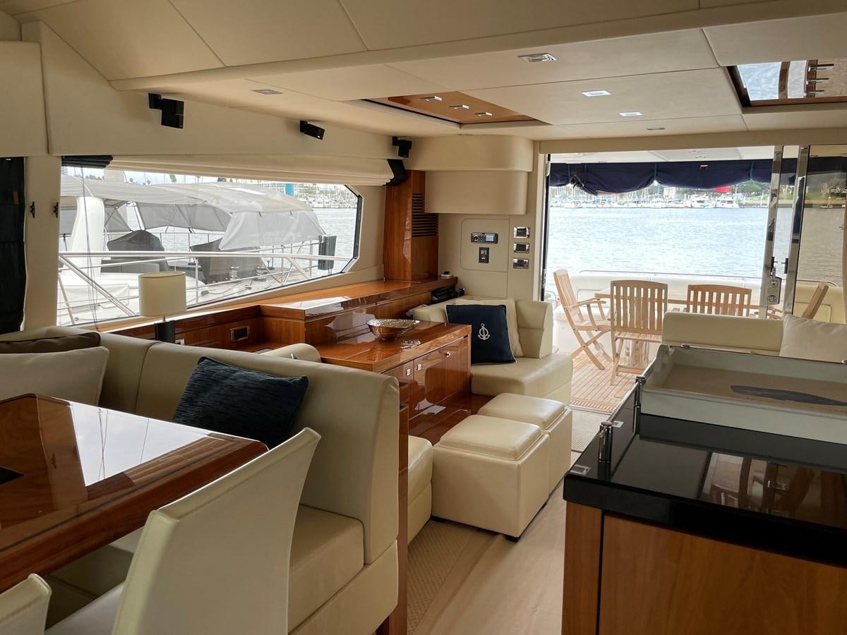 a room with a large window and chairs and tables aboard GRACE ELLEN Yacht for Sale