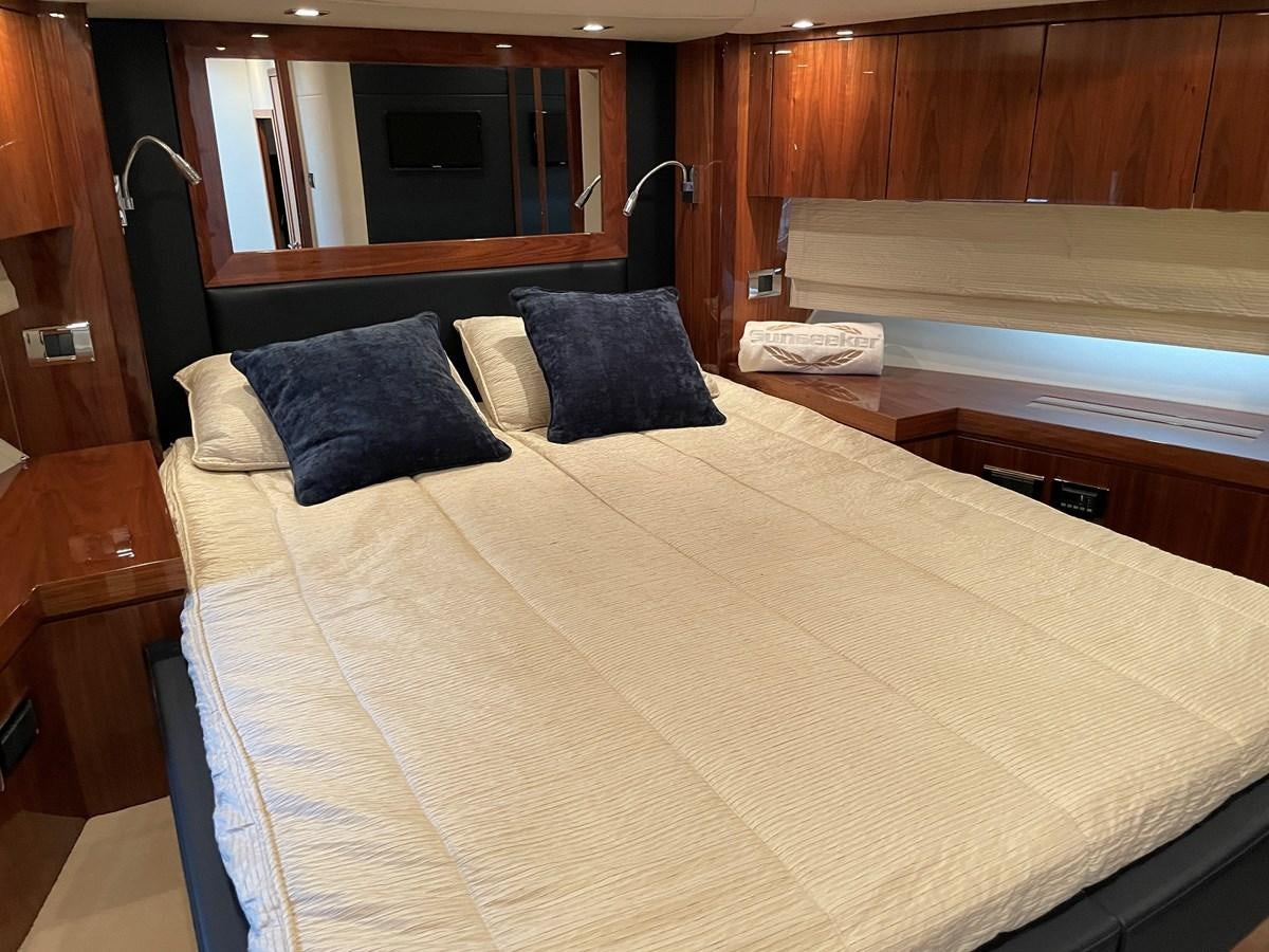 a bed with a white comforter aboard GRACE ELLEN Yacht for Sale