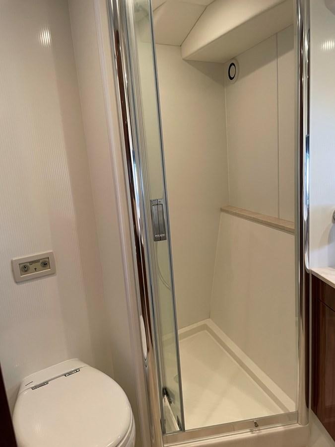 a bathroom with a glass shower door aboard GRACE ELLEN Yacht for Sale