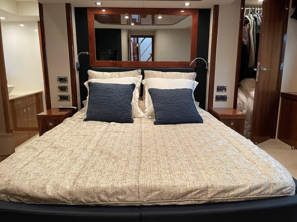 a bed with a white comforter aboard GRACE ELLEN Yacht for Sale