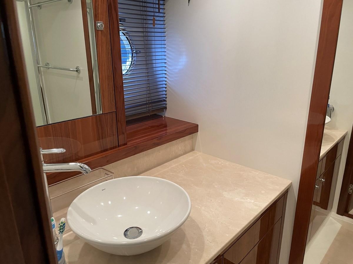 a bathroom with a sink and a mirror aboard GRACE ELLEN Yacht for Sale
