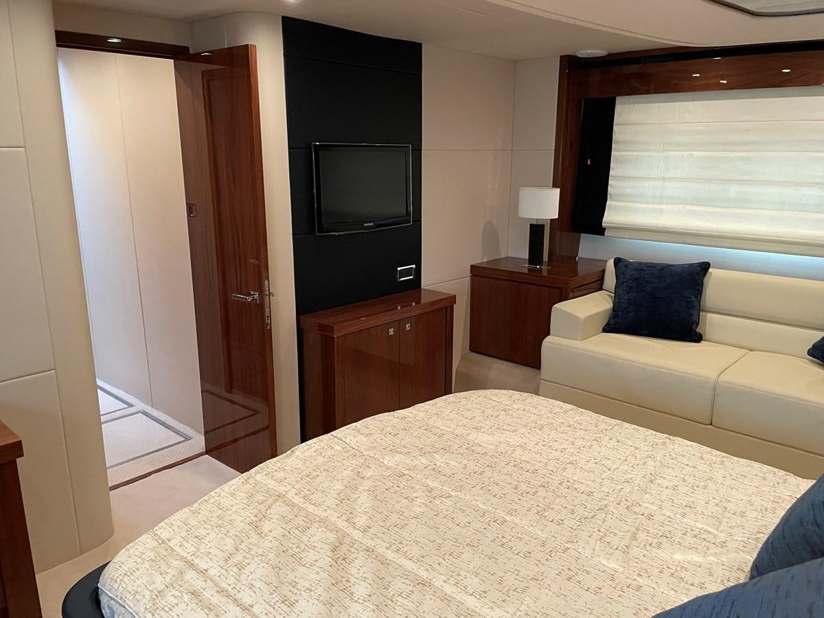 a bedroom with a bed and a television aboard GRACE ELLEN Yacht for Sale