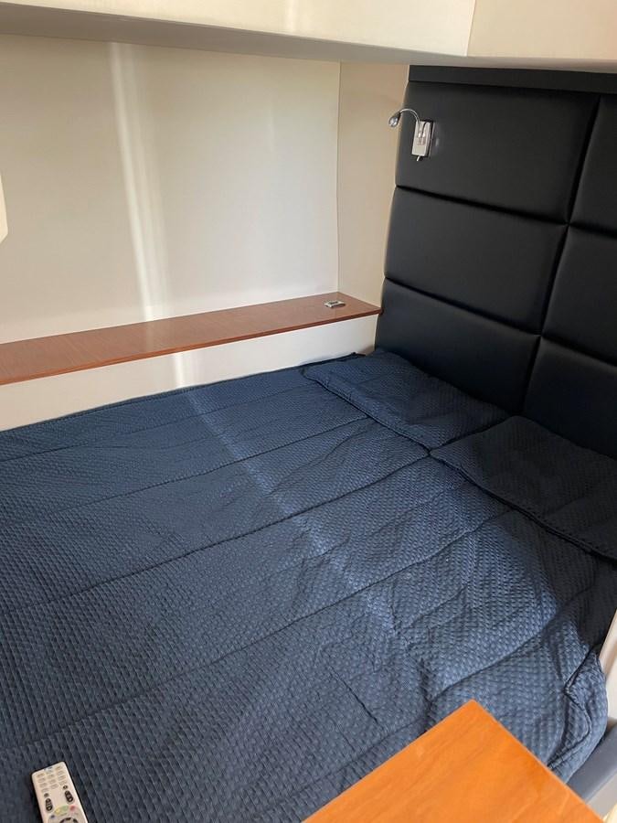 a bed with a blue comforter aboard GRACE ELLEN Yacht for Sale
