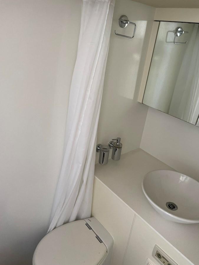 a bathroom with a sink and toilet aboard GRACE ELLEN Yacht for Sale