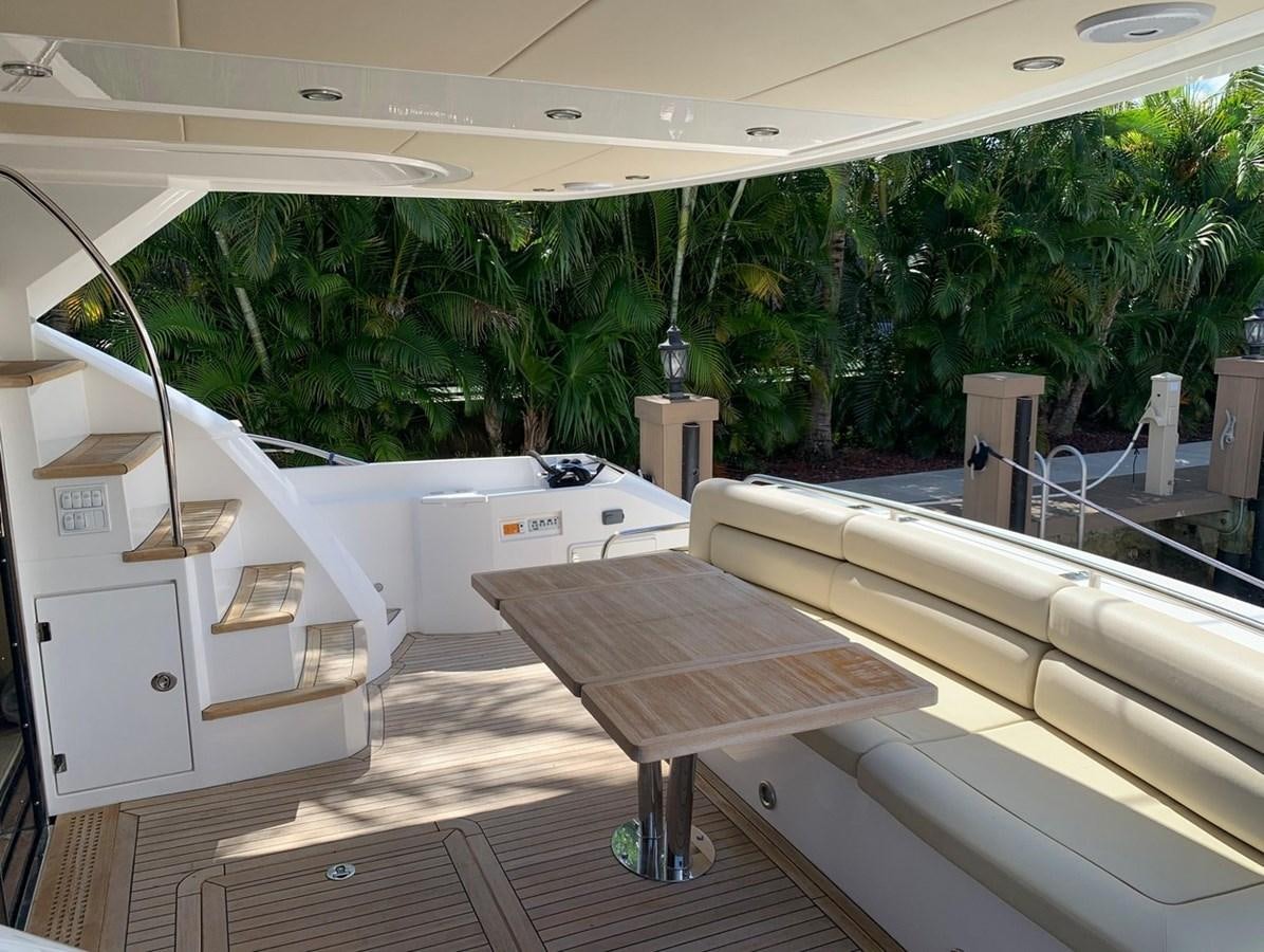 a room with white tables and white cabinets and trees aboard MOONLIGHT DRIVE Yacht for Sale