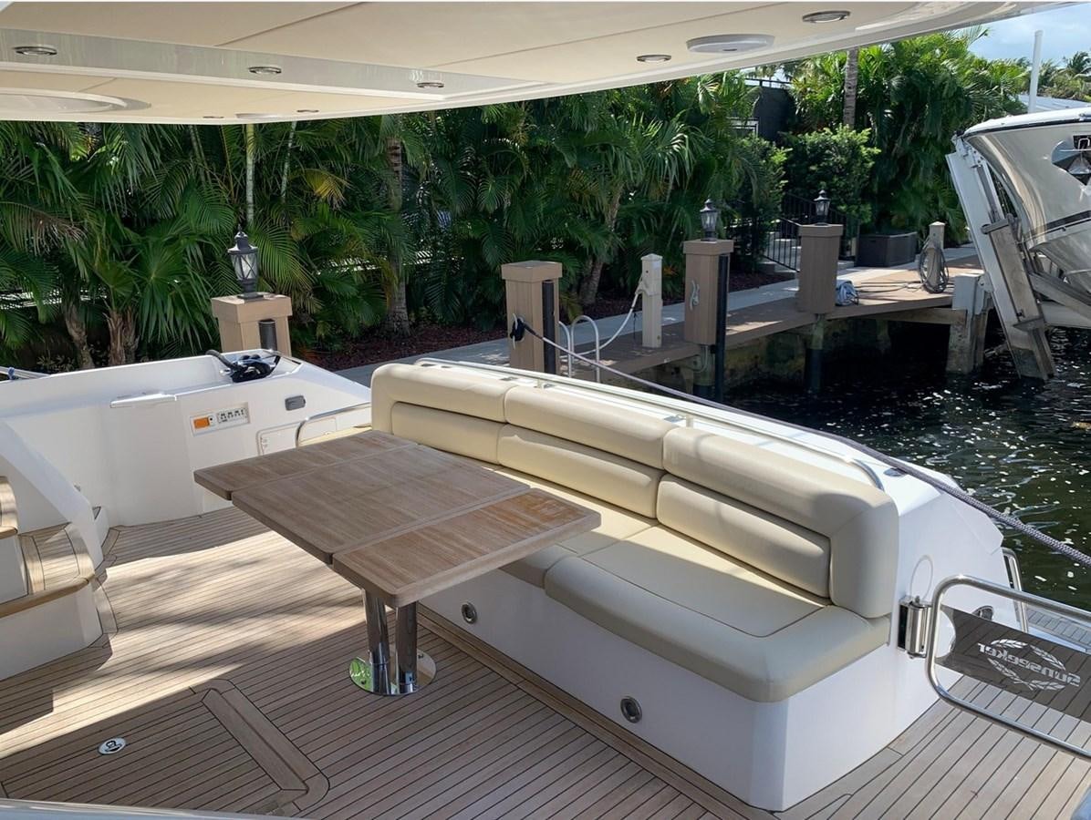 a pool with tables and chairs aboard MOONLIGHT DRIVE Yacht for Sale