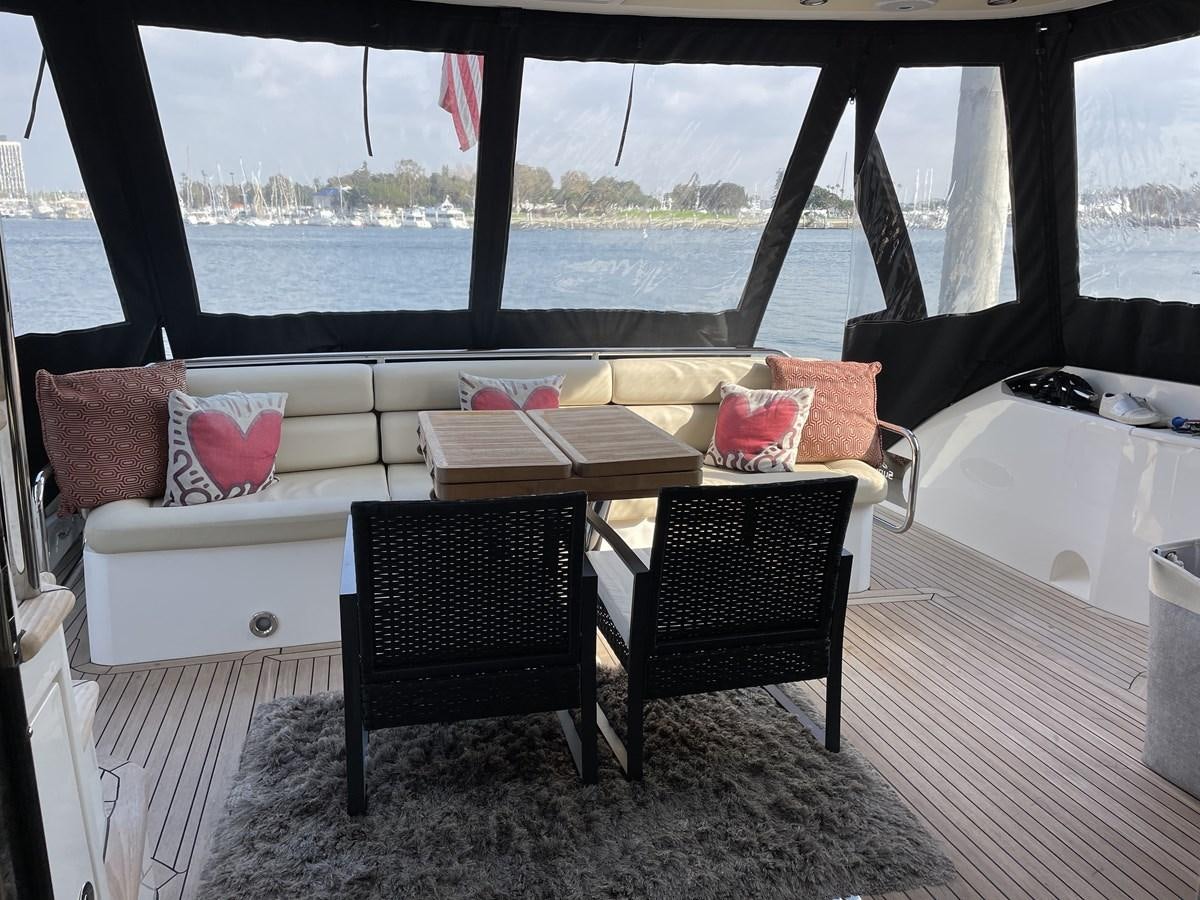a table and chairs on a balcony aboard MOONLIGHT DRIVE Yacht for Sale