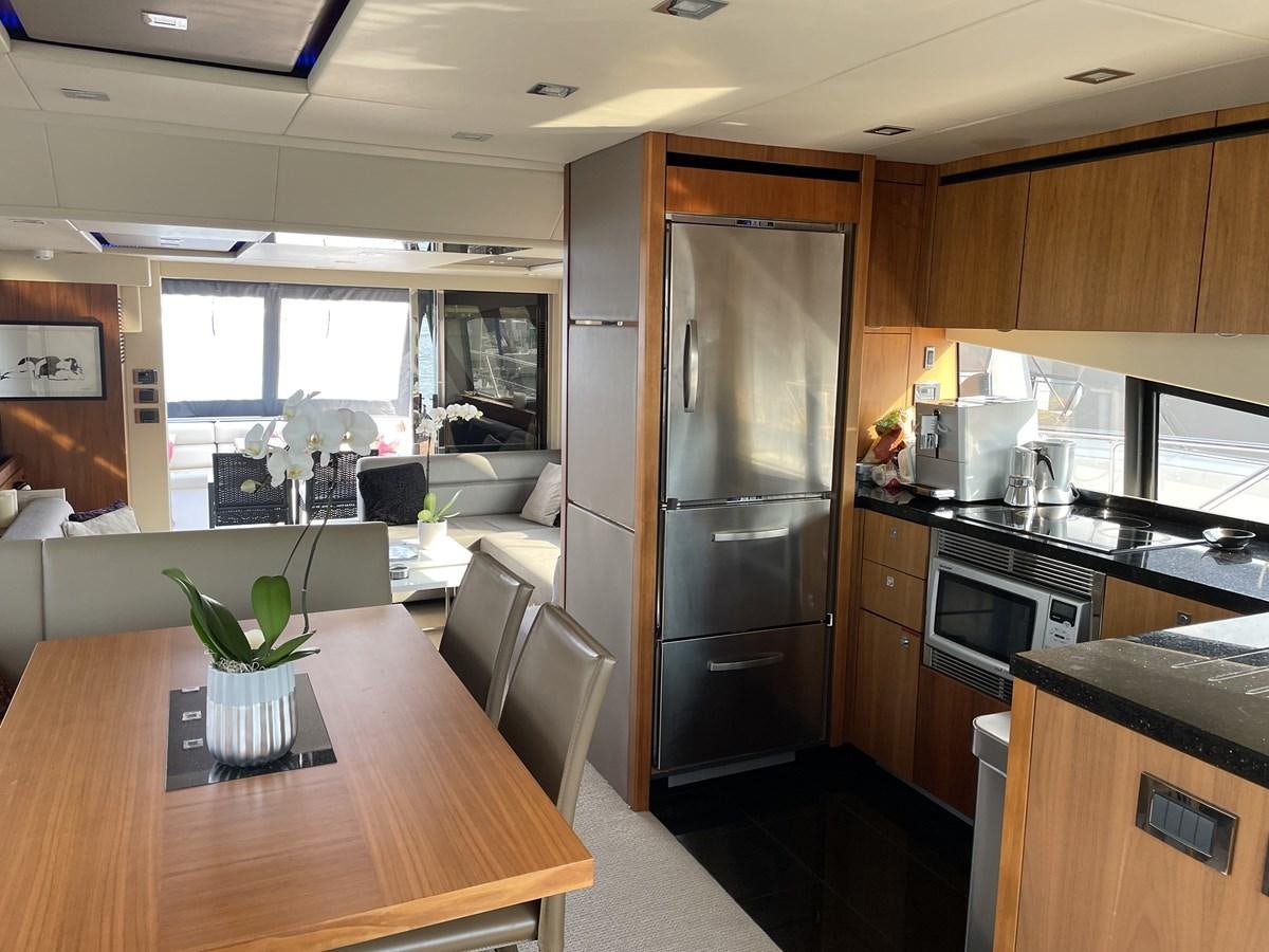 a kitchen with a table and chairs aboard MOONLIGHT DRIVE Yacht for Sale