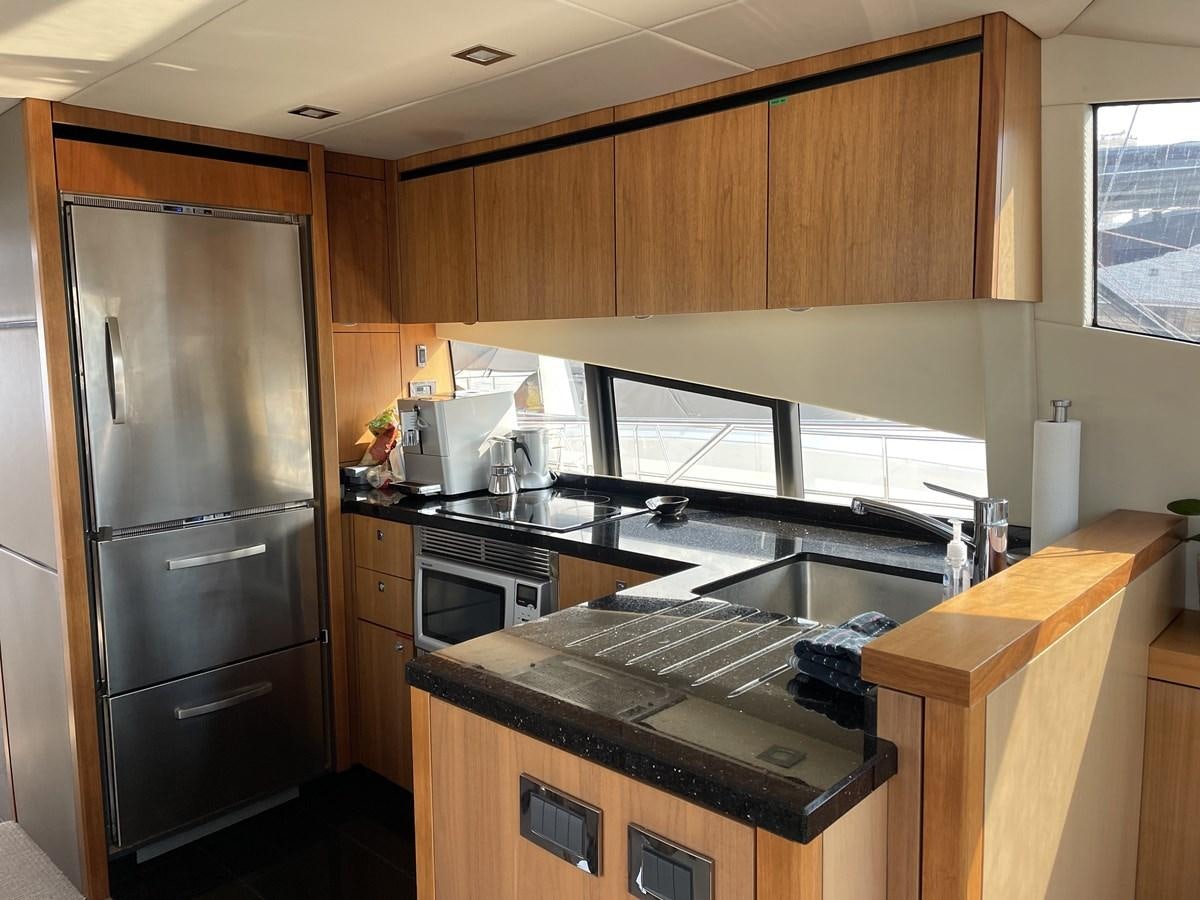 a kitchen with a refrigerator and a microwave aboard MOONLIGHT DRIVE Yacht for Sale