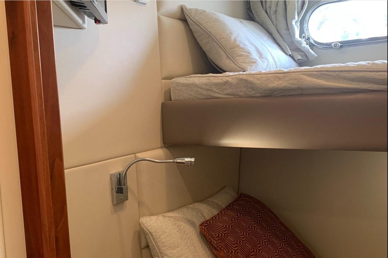 a bed with a white pillow aboard MOONLIGHT DRIVE Yacht for Sale