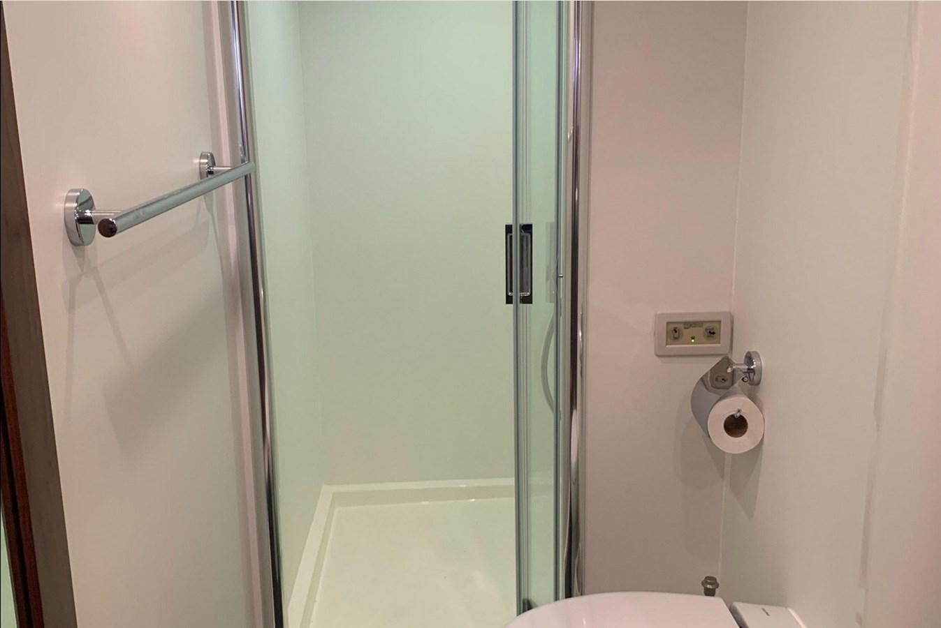 a bathroom with a toilet and a shower aboard MOONLIGHT DRIVE Yacht for Sale