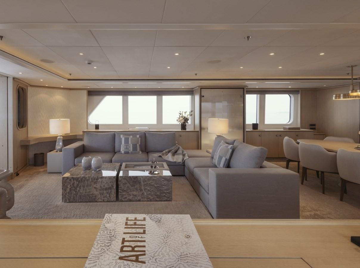 a living room with a couch and a coffee table aboard LUCKY US Yacht for Sale