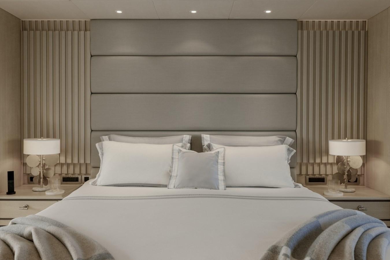 a bed with white pillows aboard LUCKY US Yacht for Sale