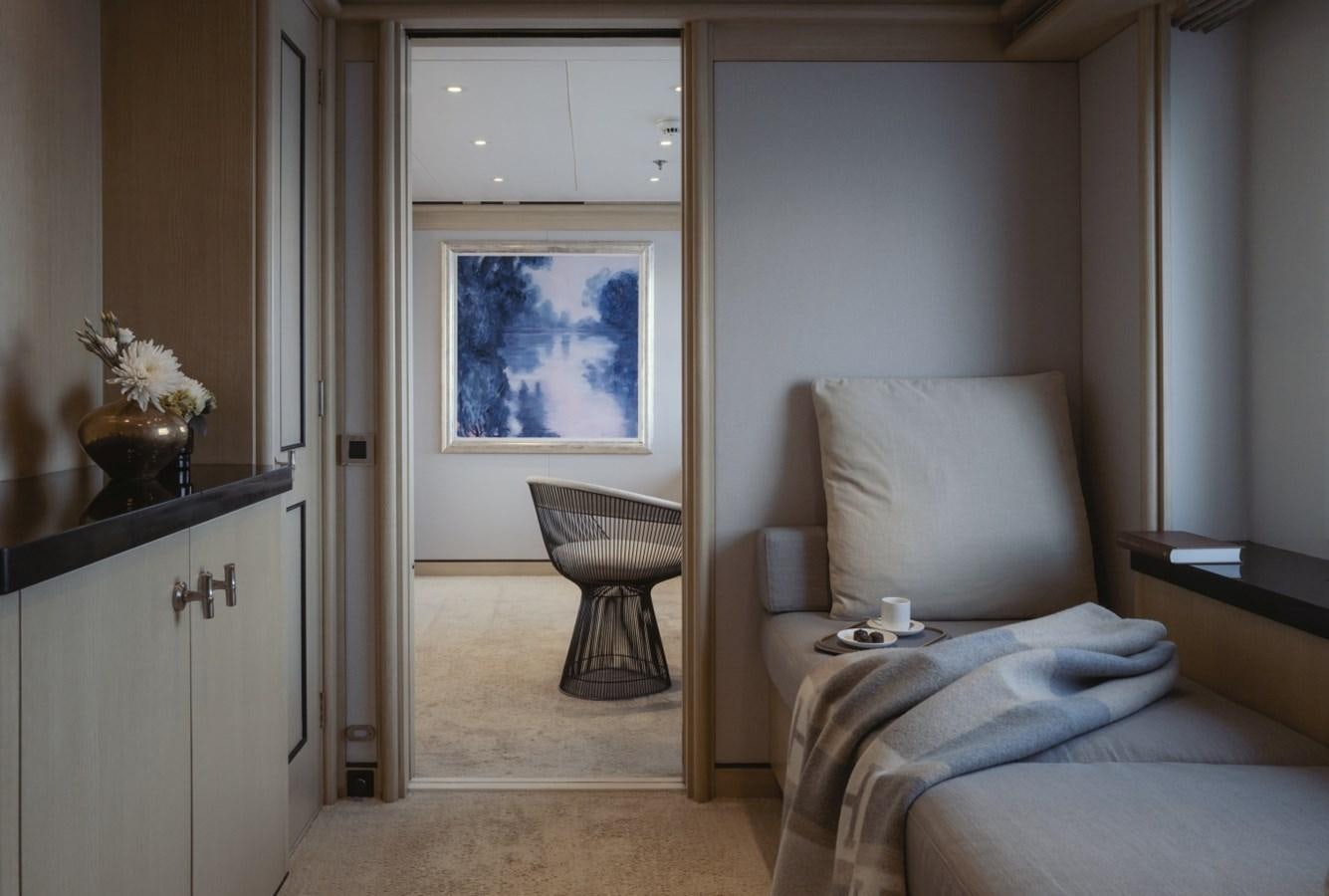 a bedroom with a bed and a chair aboard LUCKY US Yacht for Sale