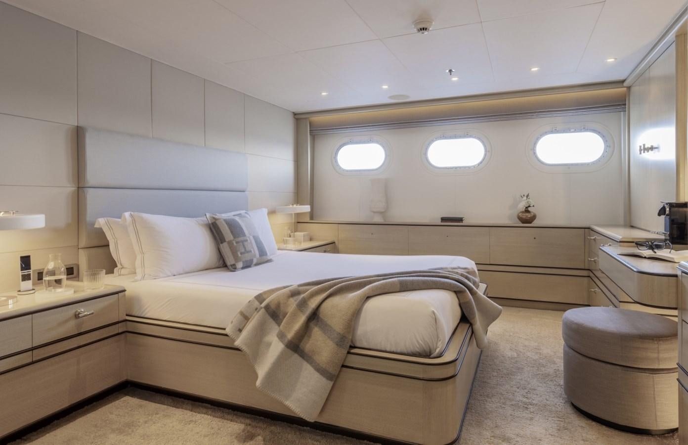 a room with a bed and a chair aboard LUCKY US Yacht for Sale