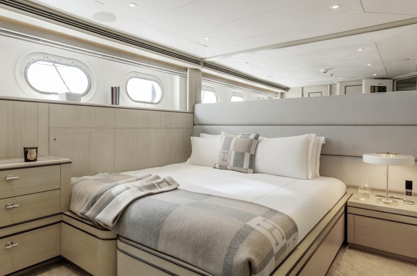 a room with a bed and a window aboard LUCKY US Yacht for Sale