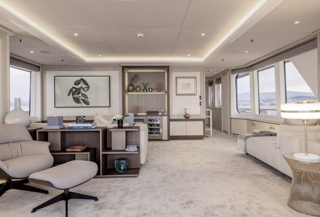 a living room with a white couch and a large window aboard LUCKY US Yacht for Sale
