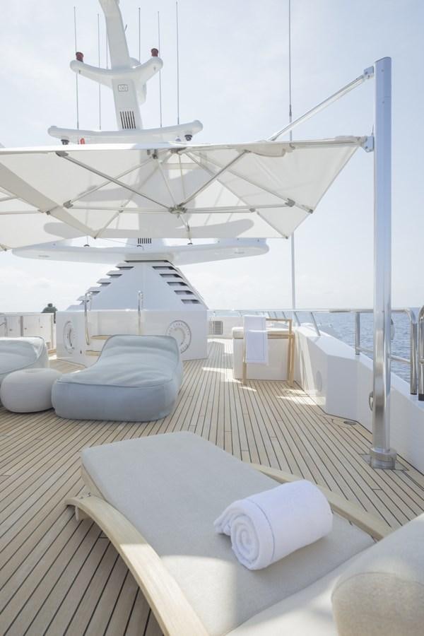 a large white airplane with a white pillow on a deck aboard LUCKY US Yacht for Sale