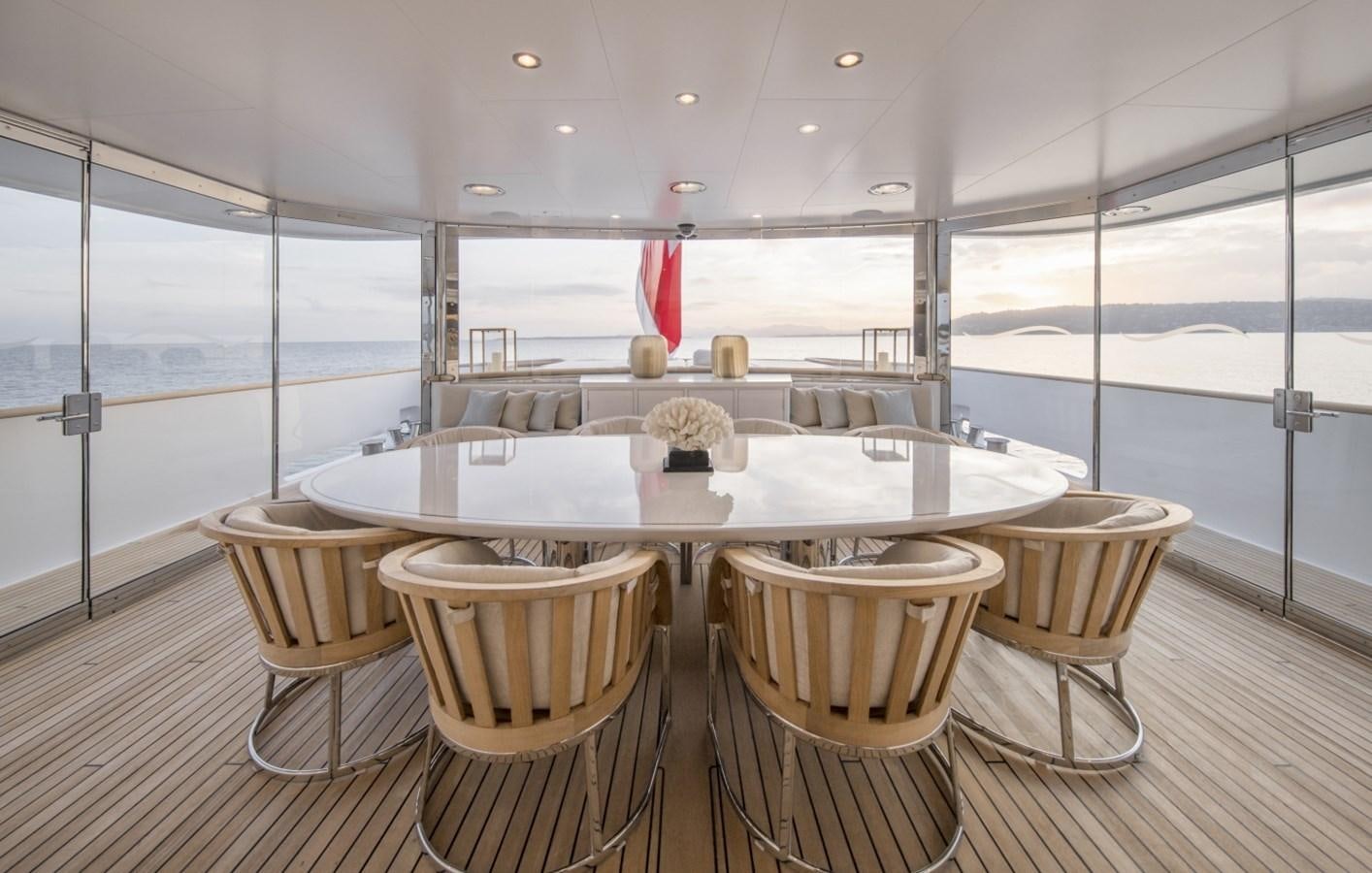 a large dining table in a room aboard LUCKY US Yacht for Sale
