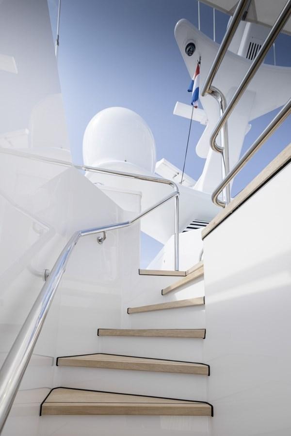 a white staircase with a white railing aboard LUCKY US Yacht for Sale