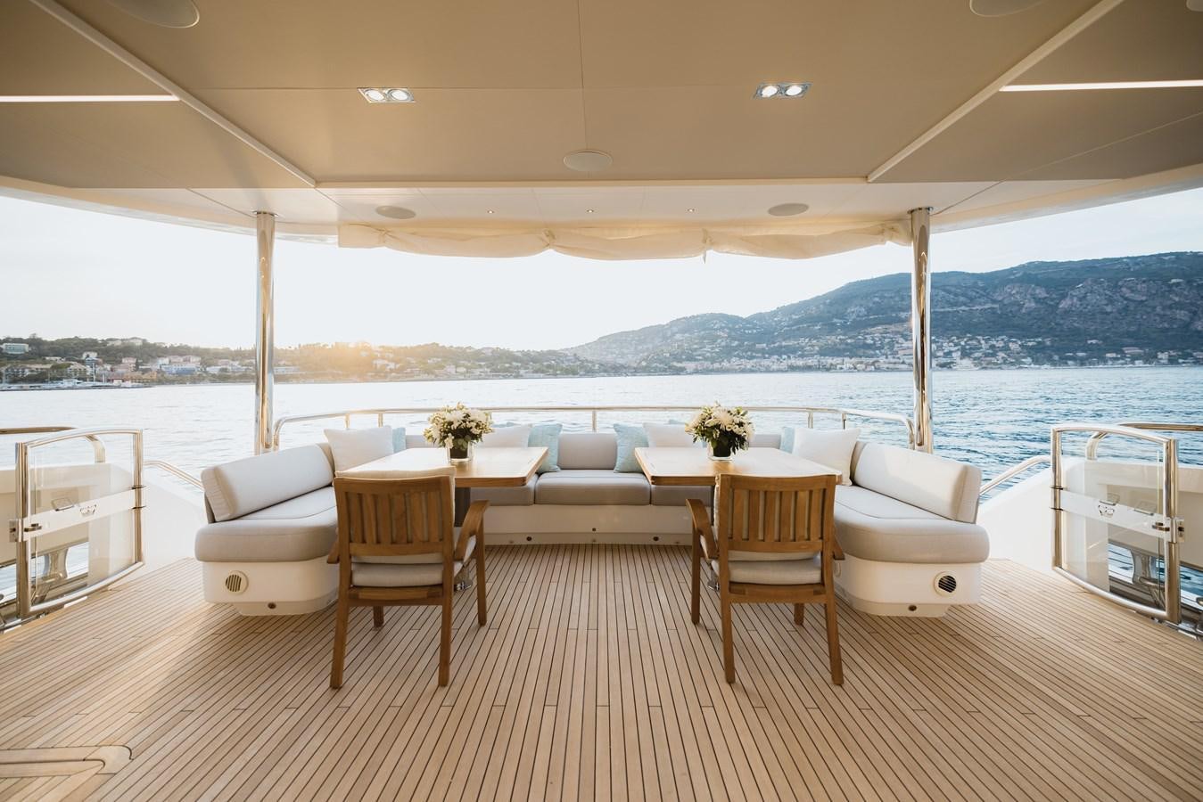 a room with a table and chairs aboard RIVIERA LIVING Yacht for Sale