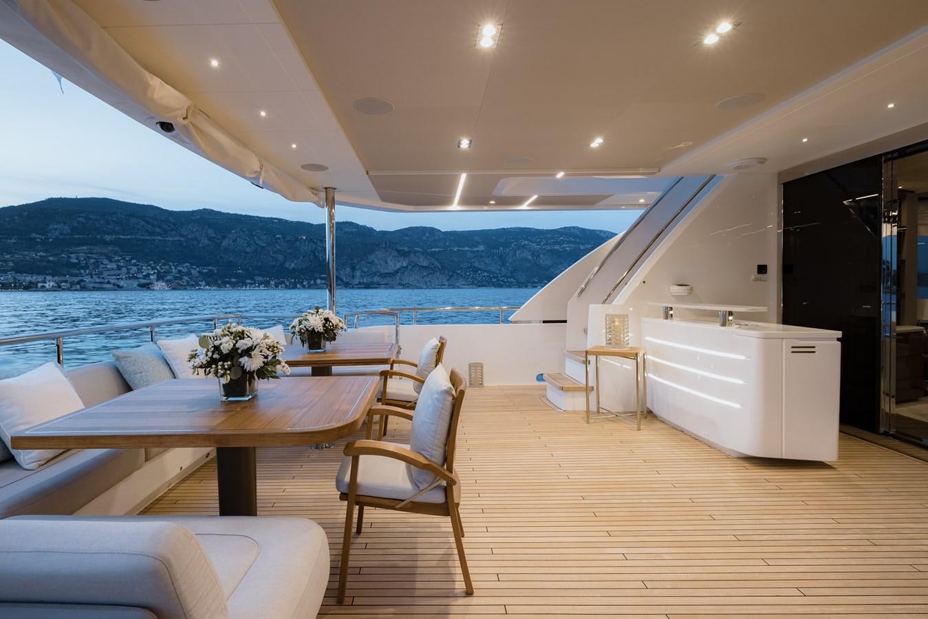a room with a table and chairs aboard RIVIERA LIVING Yacht for Sale