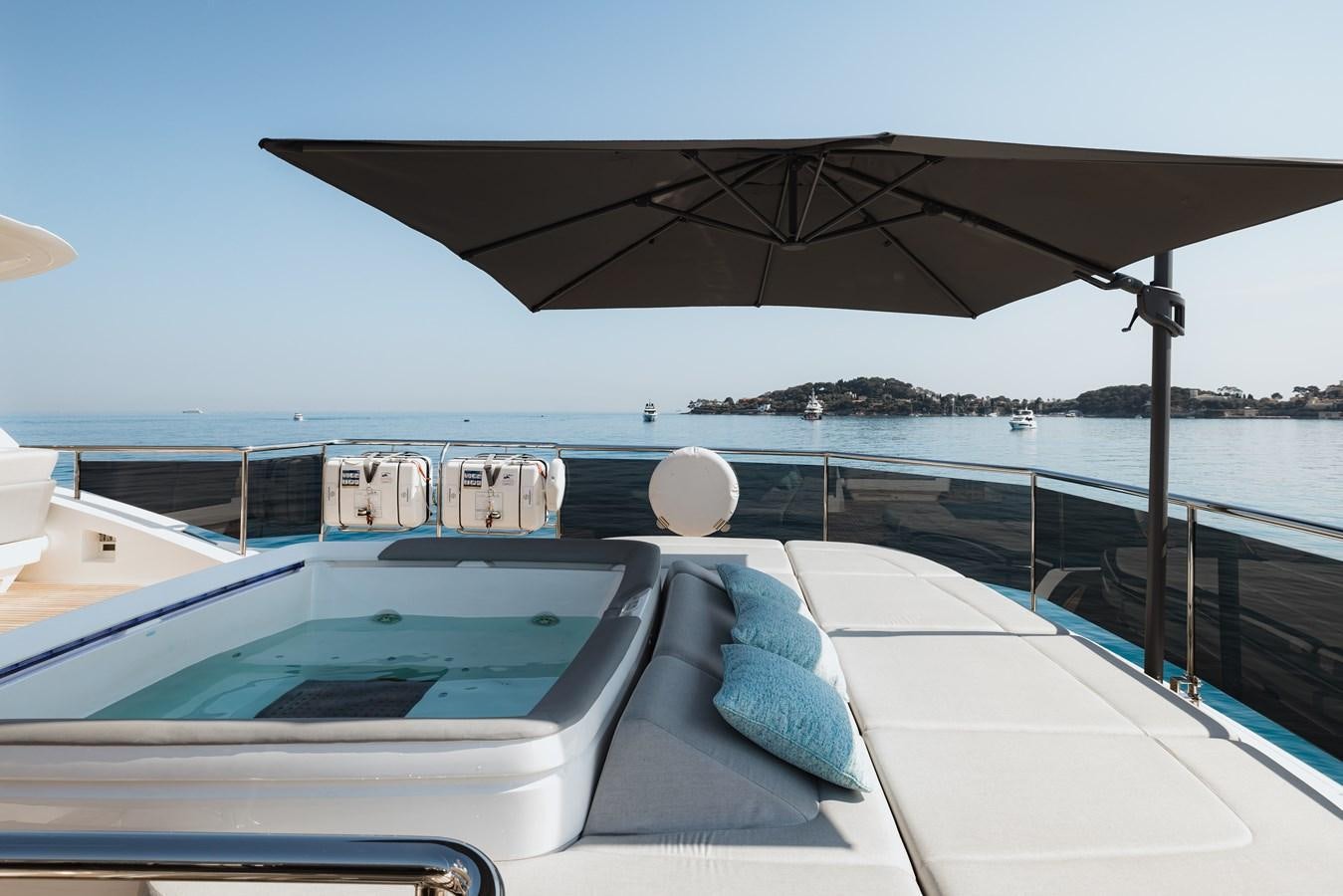 a pool with a umbrella aboard RIVIERA LIVING Yacht for Sale