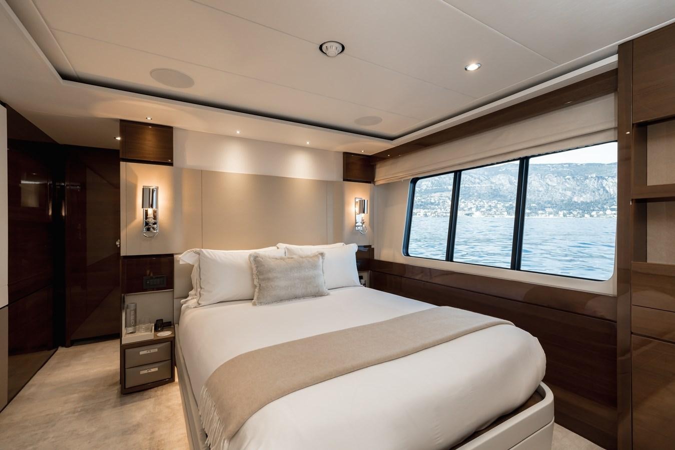 a bedroom with a bed and a window aboard RIVIERA LIVING Yacht for Sale