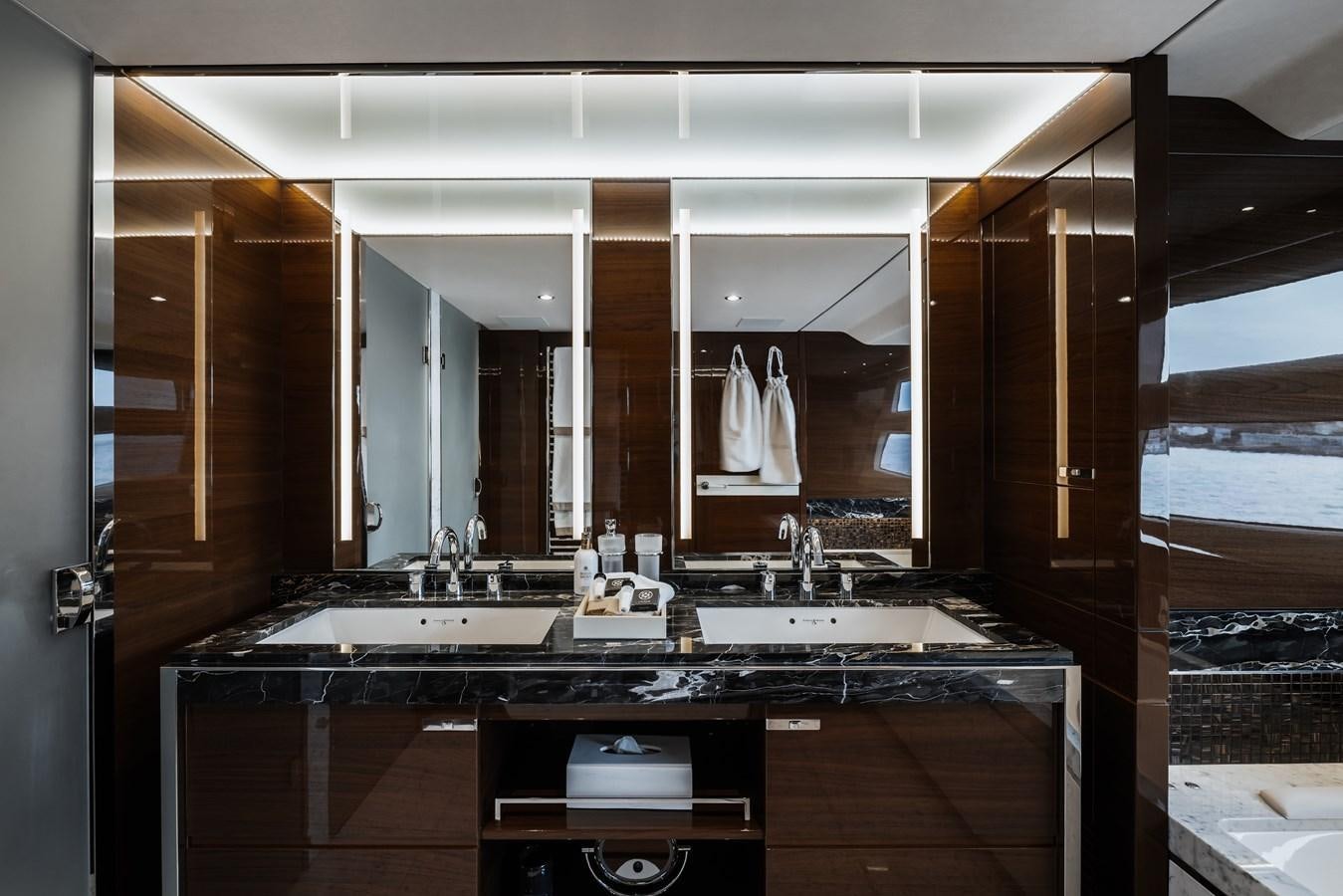 a bathroom with a large mirror aboard RIVIERA LIVING Yacht for Sale