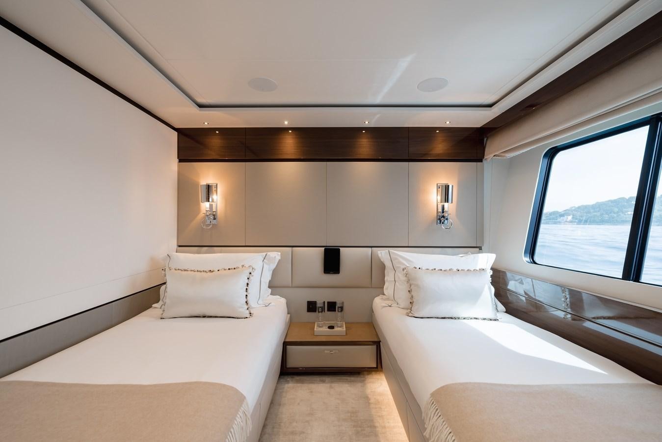 a room with two beds aboard RIVIERA LIVING Yacht for Sale