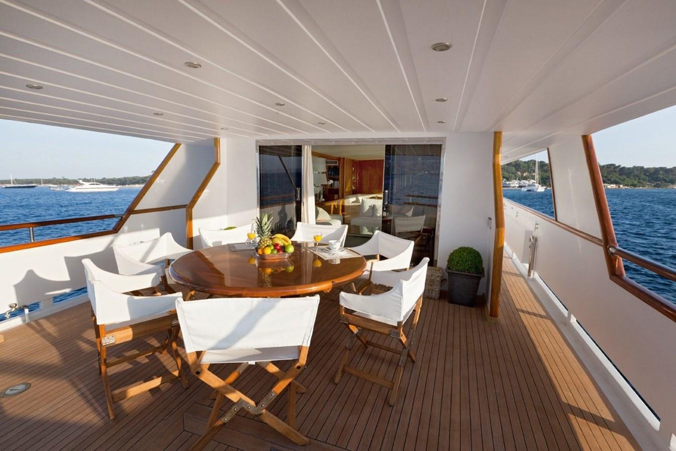 a room with a table chairs and a view of the ocean aboard DUNE Yacht for Sale