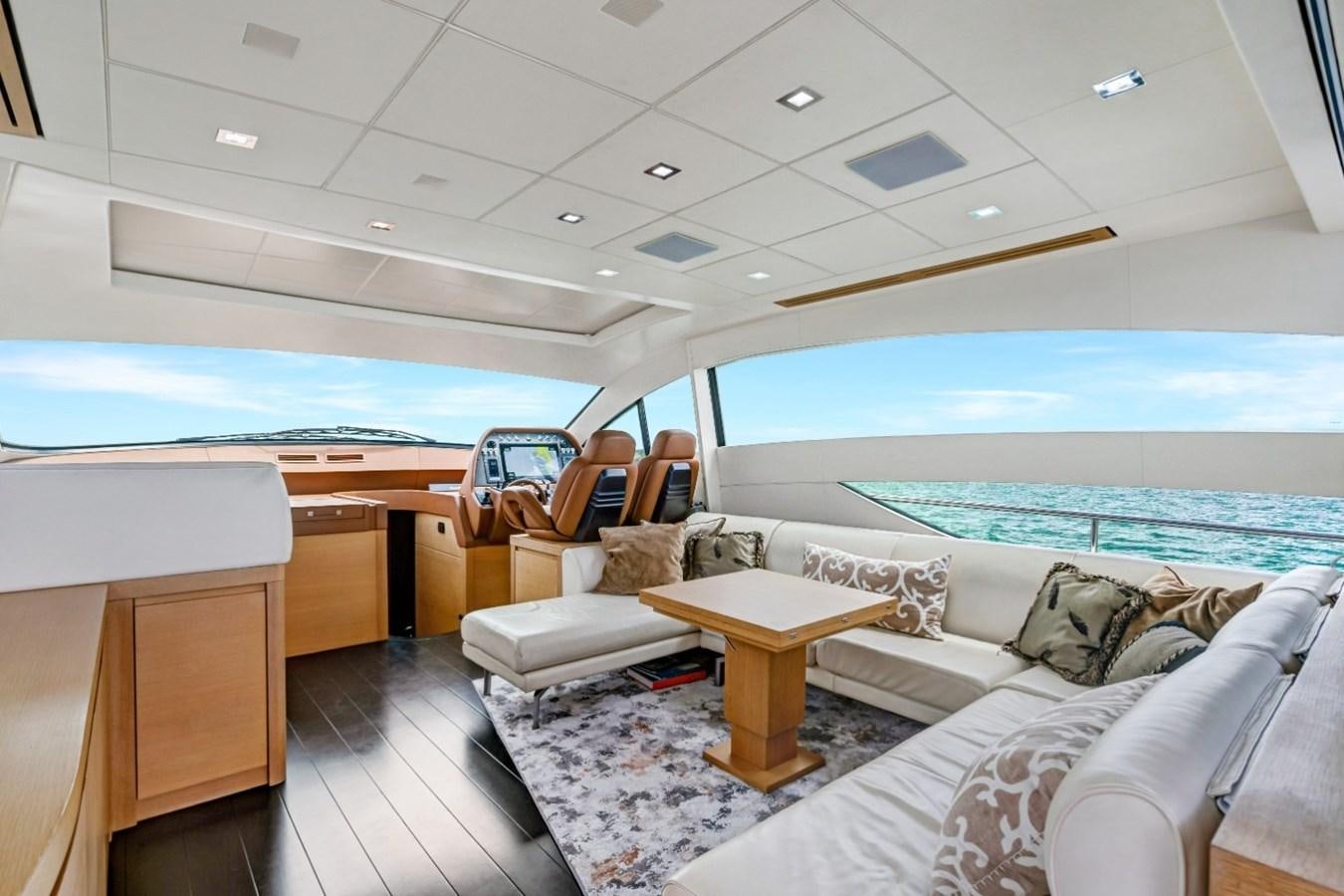 a room with a couch and a table and a large window aboard RX THERAPY  Yacht for Sale