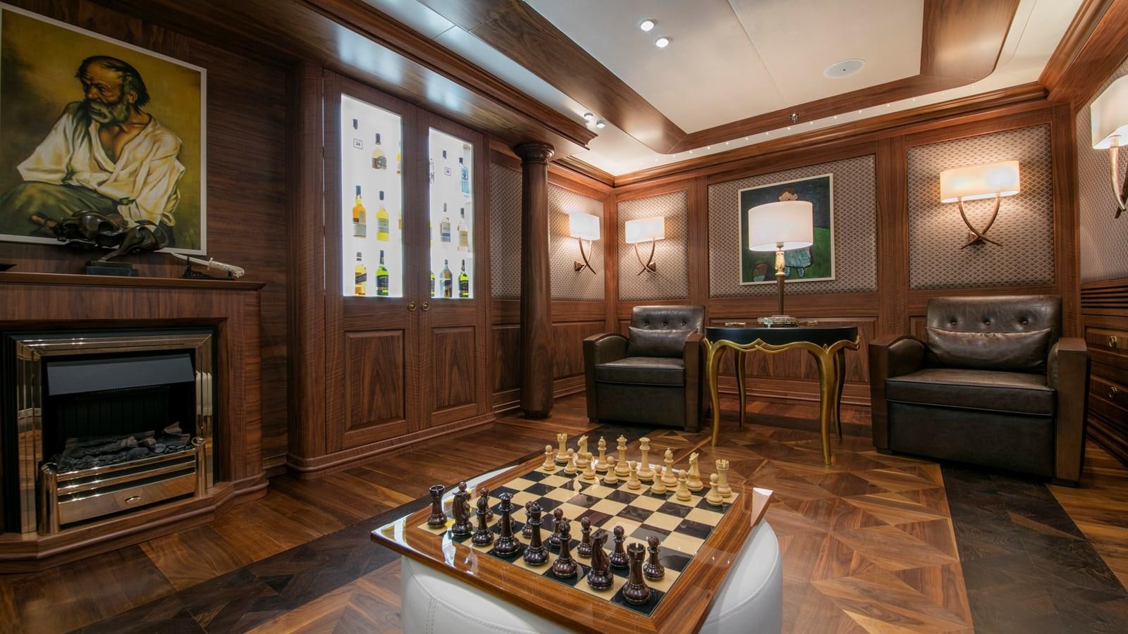 a living room with a fireplace and a table aboard KATINA Yacht for Charter