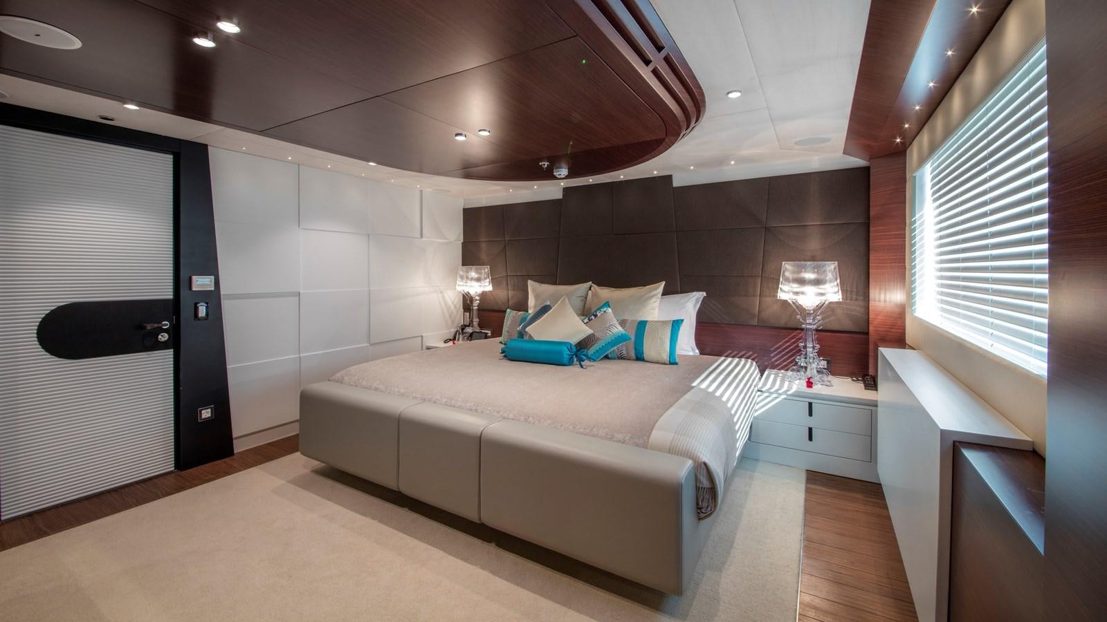 a room with a bed and a couch aboard KATINA Yacht for Charter