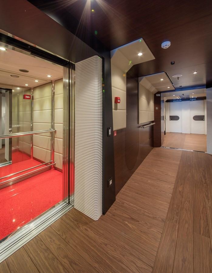 a long hallway with a red railing aboard KATINA Yacht for Charter