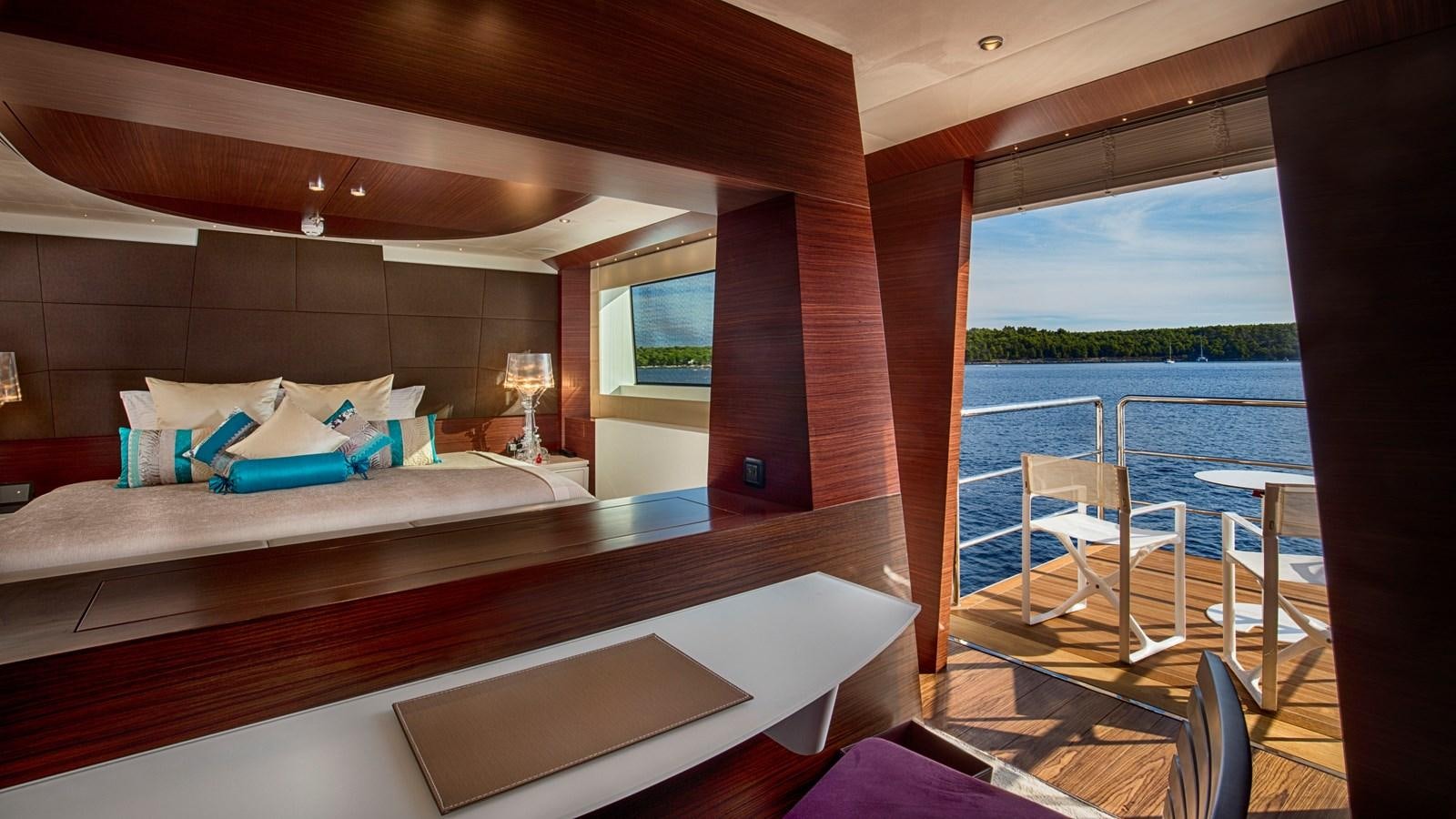 a bed with a table and chairs aboard KATINA Yacht for Charter