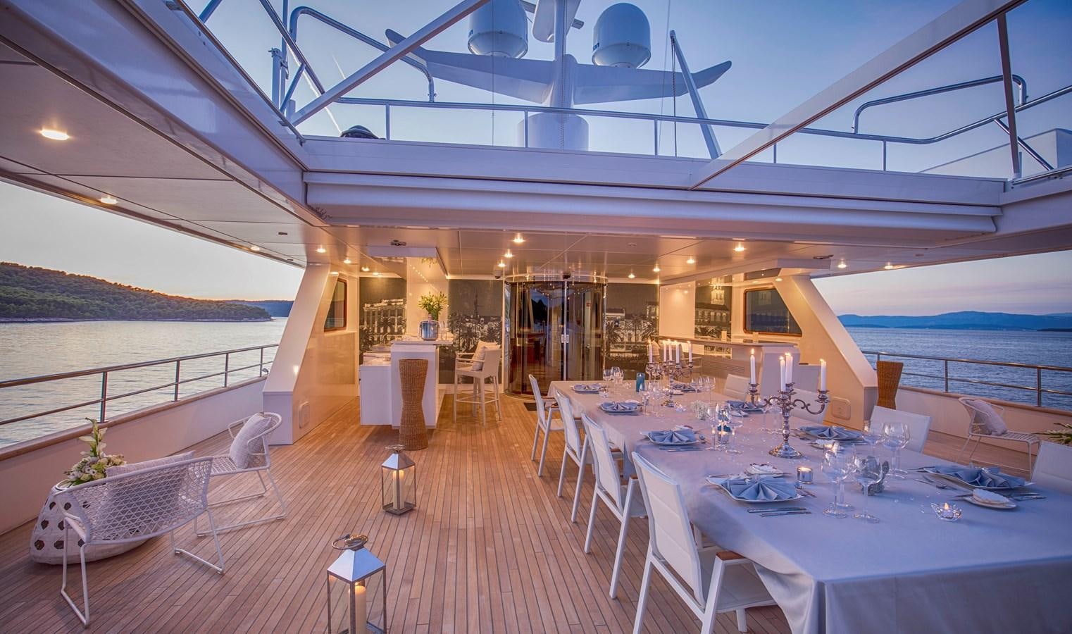 a room with tables and chairs aboard KATINA Yacht for Charter