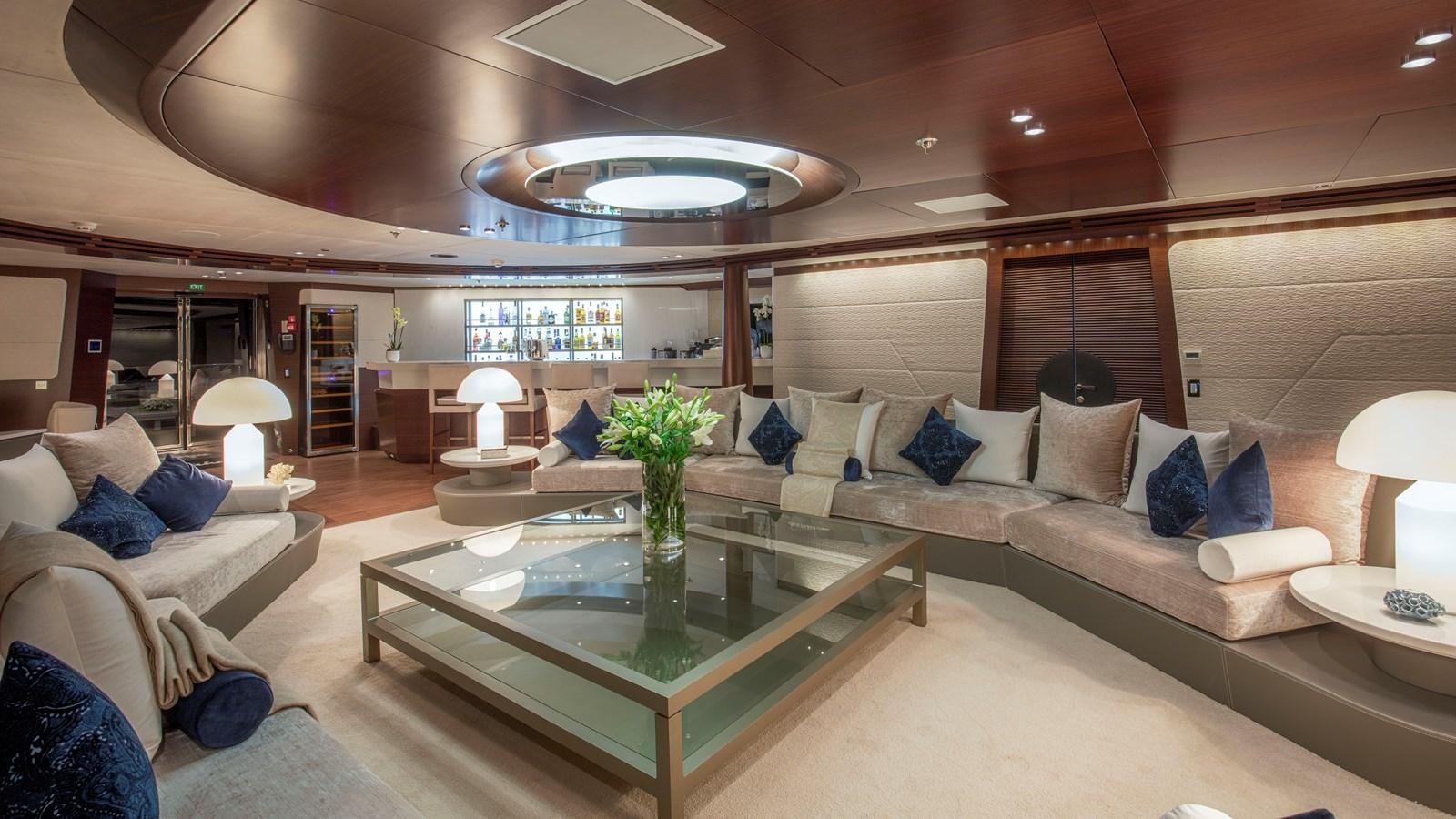 a living room with a large sofa and a coffee table aboard KATINA Yacht for Charter