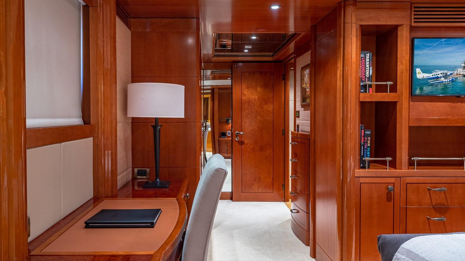 a room with a desk and a lamp aboard AS YOU WISH Yacht for Charter
