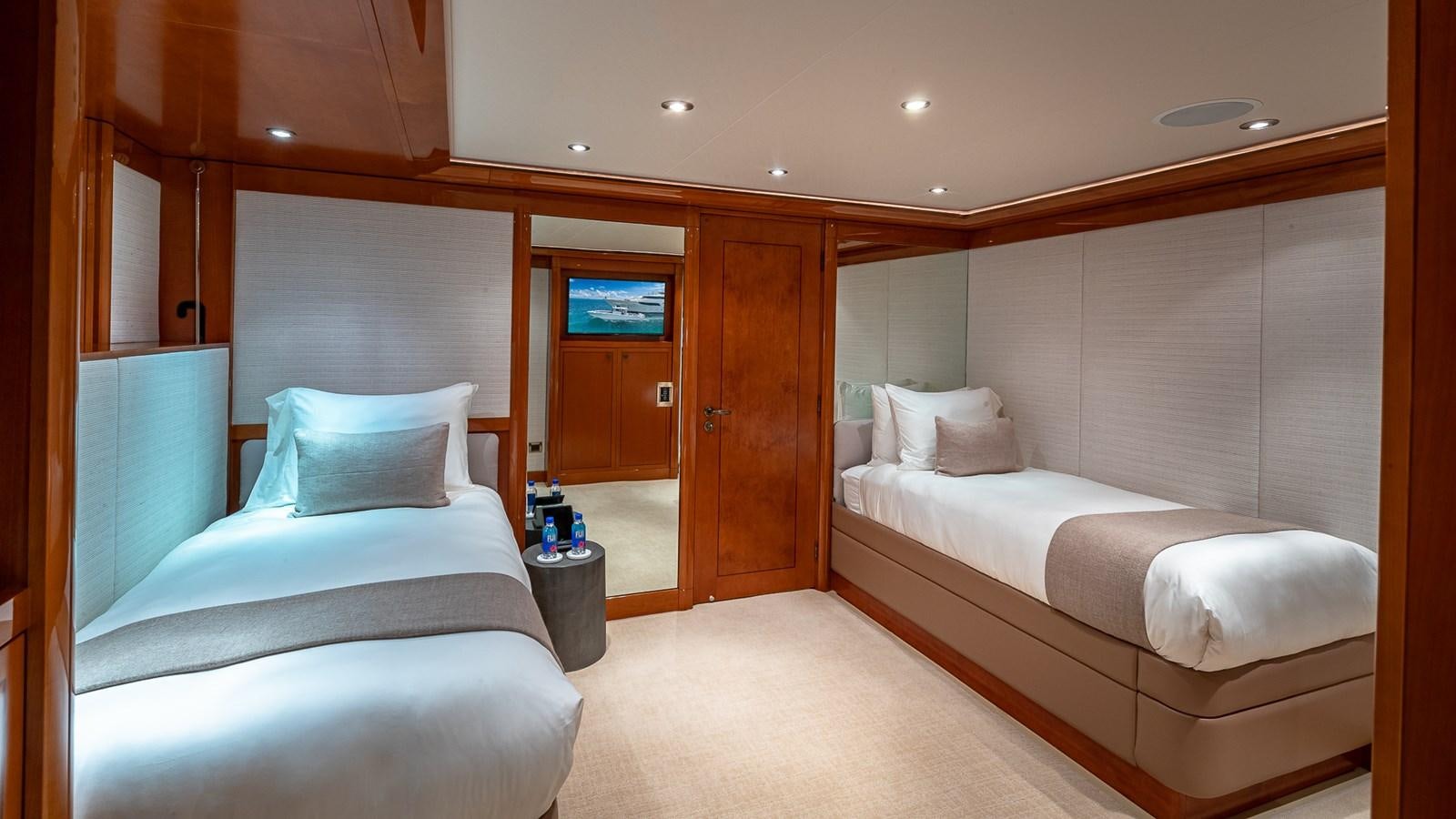 a room with a bed and a television aboard AS YOU WISH Yacht for Charter