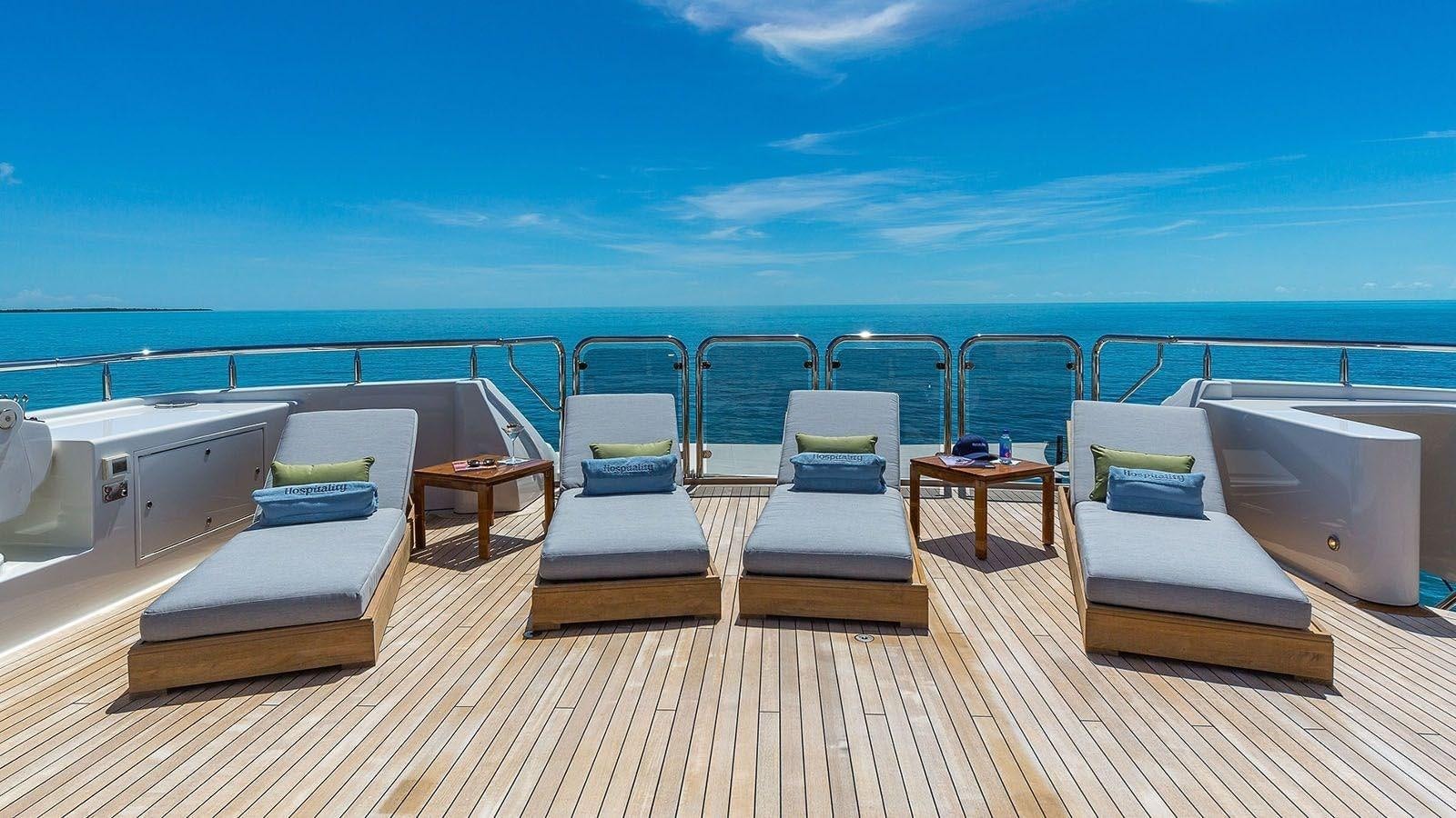a deck with chairs and tables on it aboard AS YOU WISH Yacht for Charter