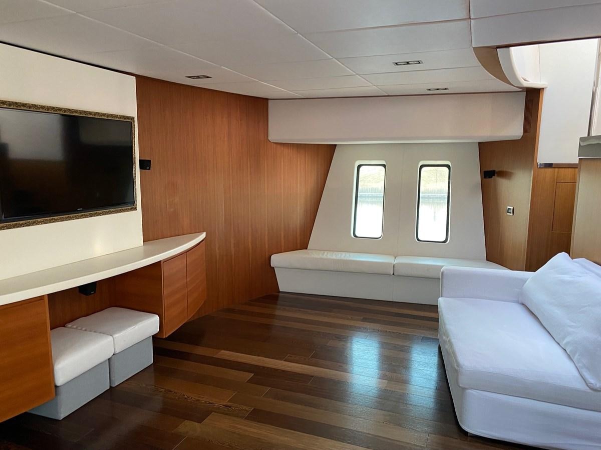 a room with a couch and a tv aboard GINEVRA Yacht for Sale